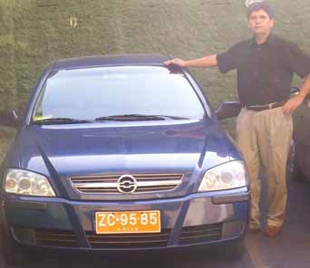 Chilean Christian Elias Pantoja Cid poses with his taxi cab